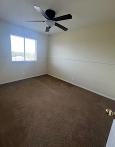 14909 Nuttall Drive Austin, TX 78724 - Photo 11 of 13 Empty room featuring dark colored carpet and a ceiling fan