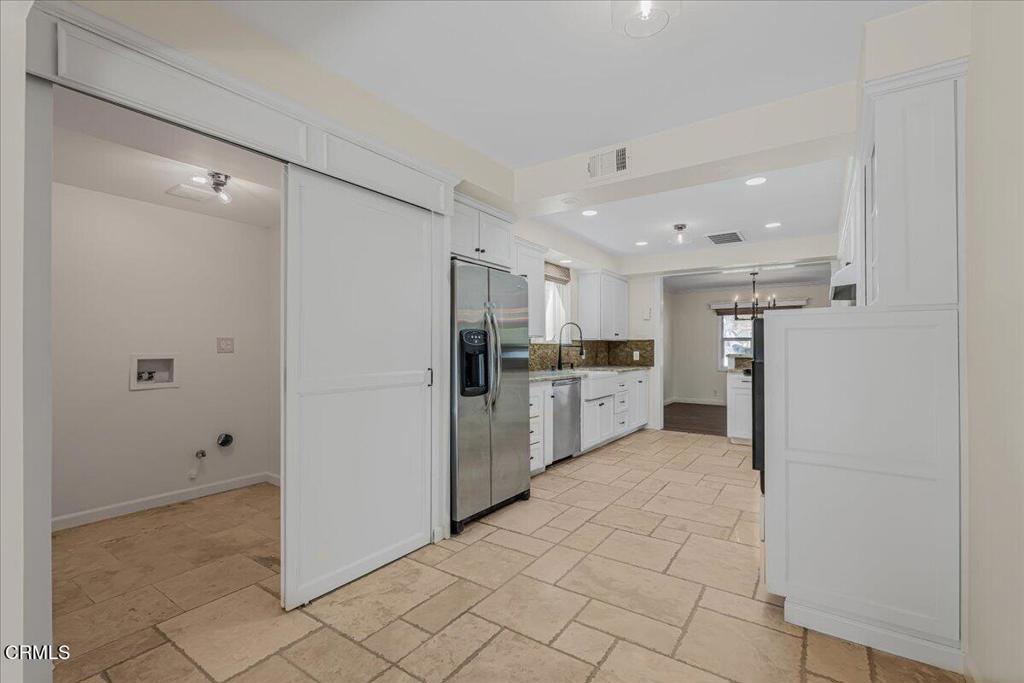 13902 Calvert Street Van Nuys, CA 91401 - Photo 12 of 33 a view of kitchen with refrigerator cabinets and wooden floor