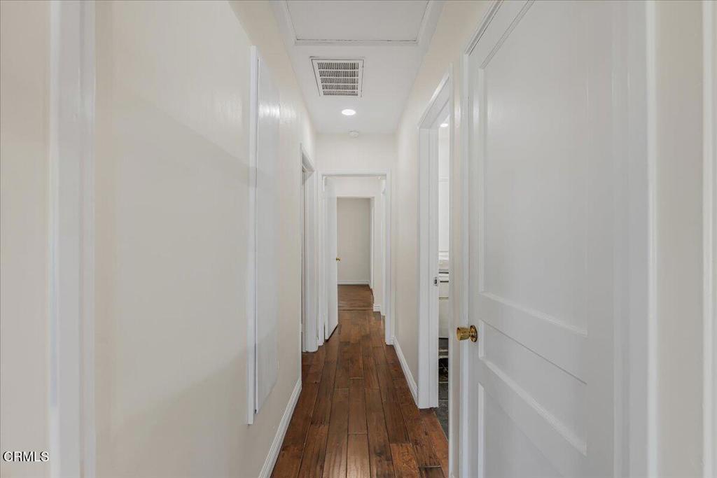 13902 Calvert Street Van Nuys, CA 91401 - Photo 15 of 33 a view of a hallway with a wooden floor