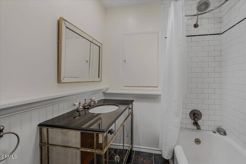 13902 Calvert Street Van Nuys, CA 91401 - Photo 16 of 33 a bathroom with a sink and a mirror