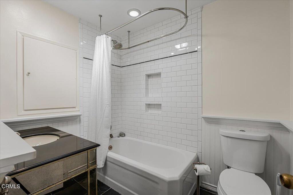 13902 Calvert Street Van Nuys, CA 91401 - Photo 17 of 33 a bathroom with a sink toilet vanity and shower
