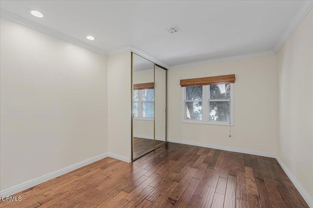 13902 Calvert Street Van Nuys, CA 91401 - Photo 19 of 33 an empty room with wooden floor and window