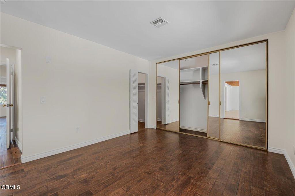 13902 Calvert Street Van Nuys, CA 91401 - Photo 23 of 33 an empty room with wooden floor