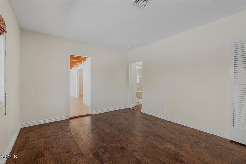 13902 Calvert Street Van Nuys, CA 91401 - Photo 26 of 33 an empty room with wooden floor and windows