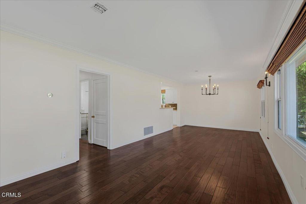 13902 Calvert Street Van Nuys, CA 91401 - Photo 4 of 33 an empty room with wooden floor and windows