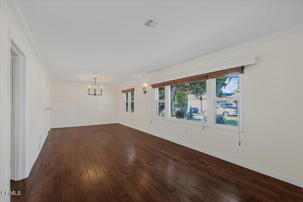 13902 Calvert Street Van Nuys, CA 91401 - Photo 7 of 33 an empty room with wooden floor and windows