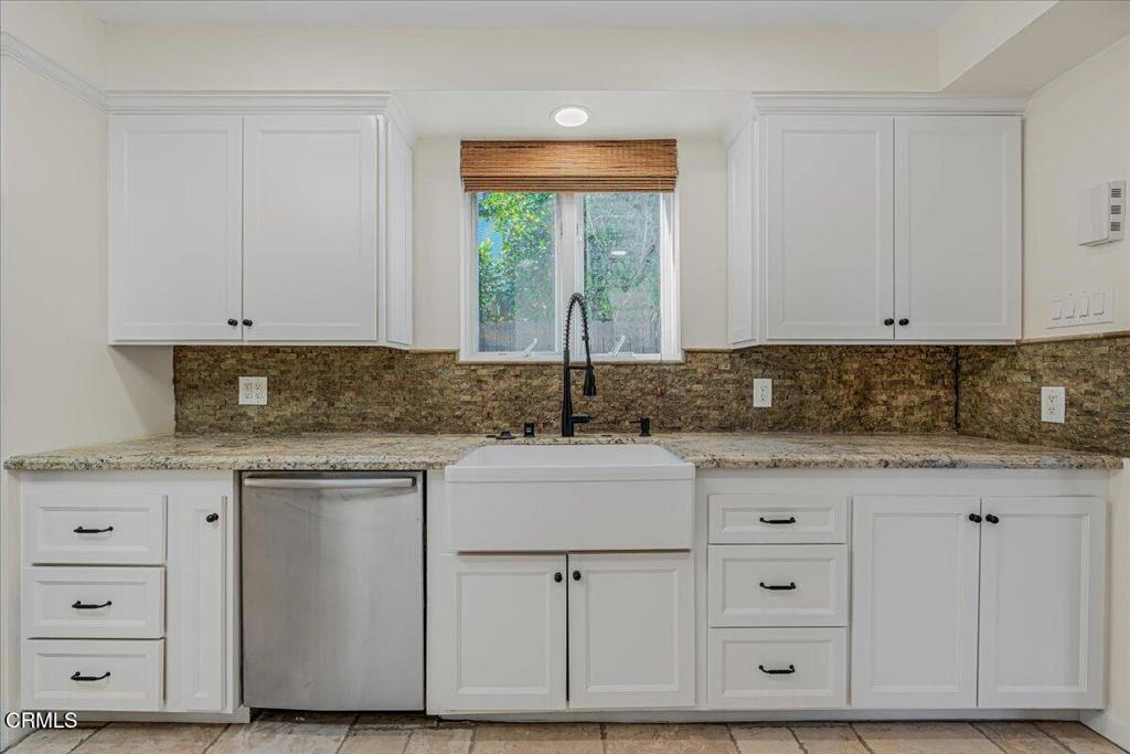 13902 Calvert Street Van Nuys, CA 91401 - Photo 9 of 33 a kitchen with granite countertop a sink and cabinets