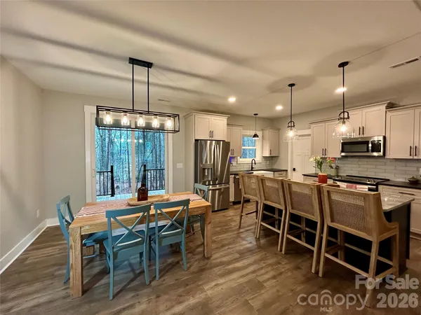 a dining room with glass top table and chairs
