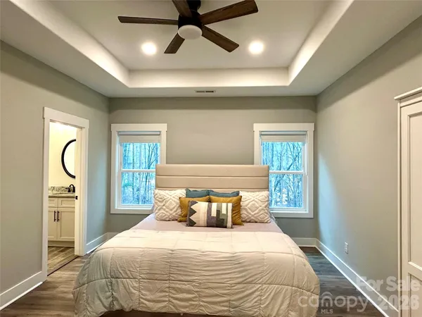a bedroom with a large bed and a chandelier