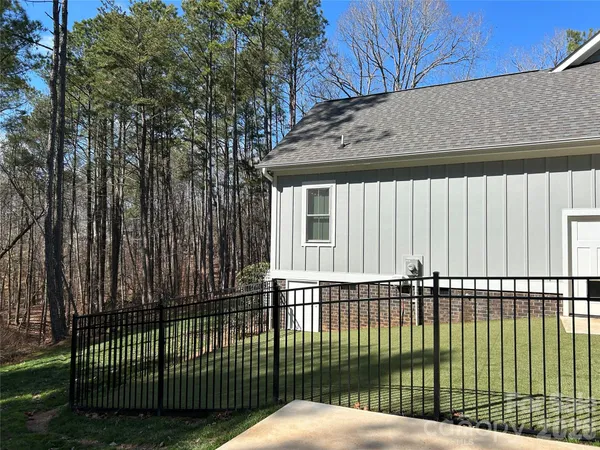 a view of a backyard with fence