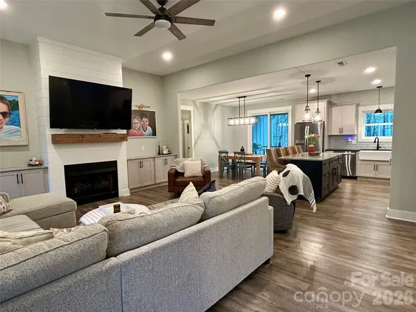 a living room with furniture fireplace and a flat screen tv