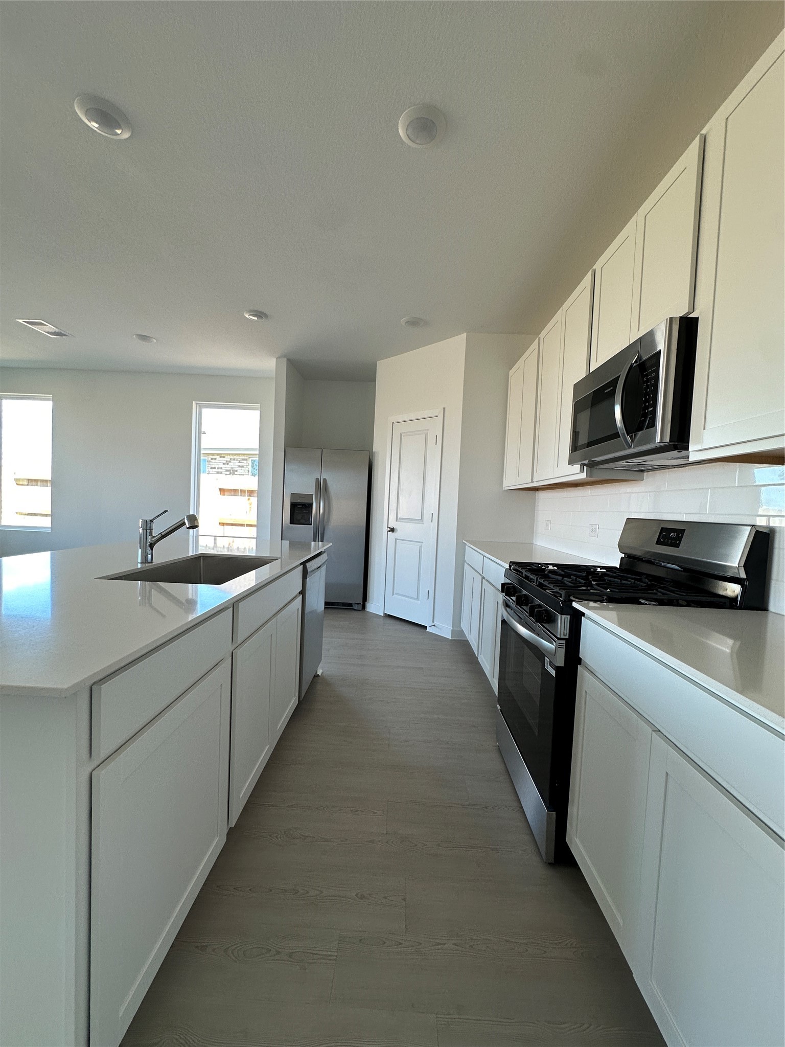 3124 Ruby Ridge Drive Katy, TX 77493 - Photo 2 of 12 a kitchen with stainless steel appliances granite countertop a stove a sink and a microwave