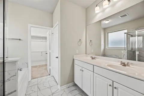 a spacious bathroom with a granite countertop sink a mirror and a shower