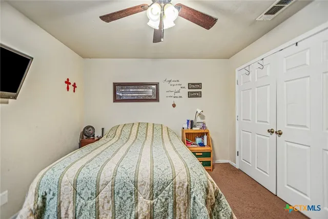 a bedroom with a bed and a tv