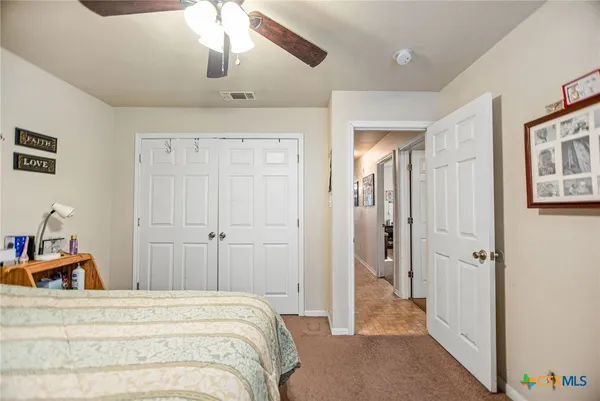 a view of a bedroom with a bed and hallway