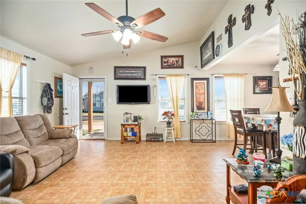 a living room with furniture and a flat screen tv