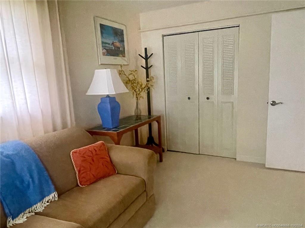 1225 Northwest 21st Street, Unit 3014 Stuart, FL 34994 - Photo 15 of 37 a living room with furniture and a window