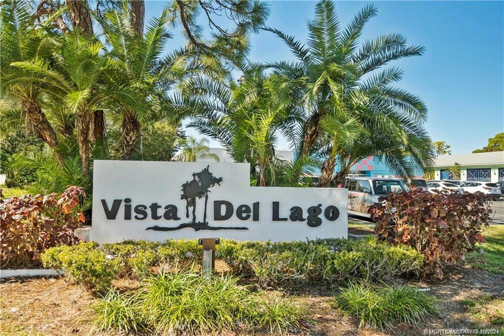 1225 Northwest 21st Street, Unit 3014 Stuart, FL 34994 - Photo 2 of 37 a view of sign board with large trees