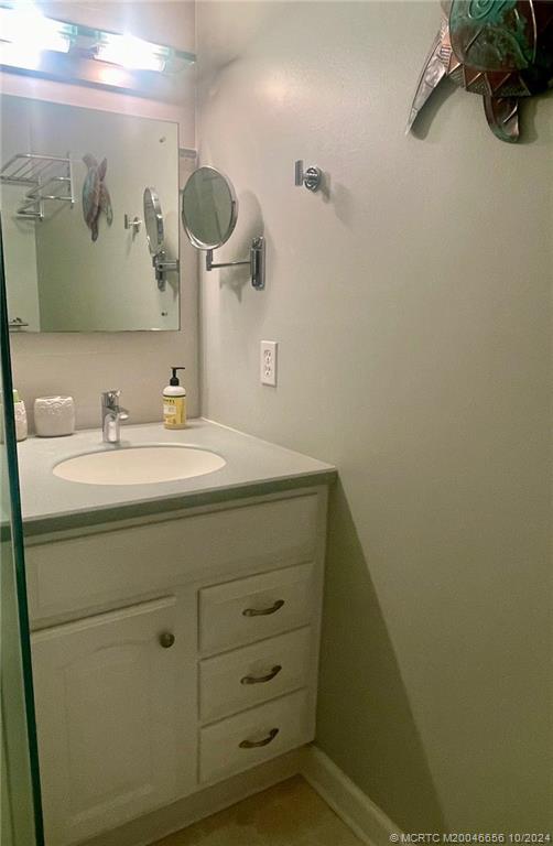 1225 Northwest 21st Street, Unit 3014 Stuart, FL 34994 - Photo 22 of 37 a bathroom with a sink and a mirror