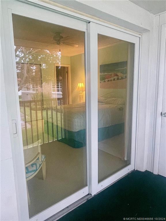 1225 Northwest 21st Street, Unit 3014 Stuart, FL 34994 - Photo 29 of 37 a bathroom with a glass shower door