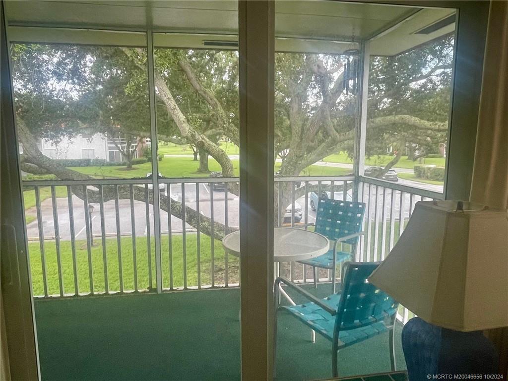 1225 Northwest 21st Street, Unit 3014 Stuart, FL 34994 - Photo 30 of 37 a view of a porch and a yard