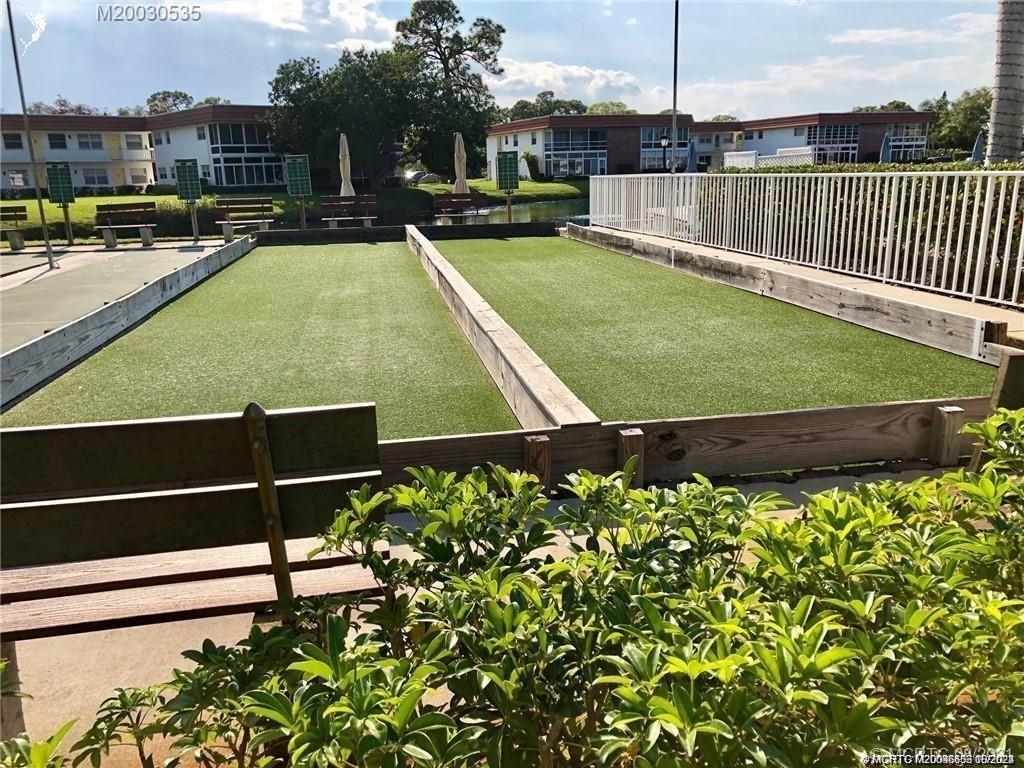 1225 Northwest 21st Street, Unit 3014 Stuart, FL 34994 - Photo 33 of 37 a view of a swimming pool with a garden and deck