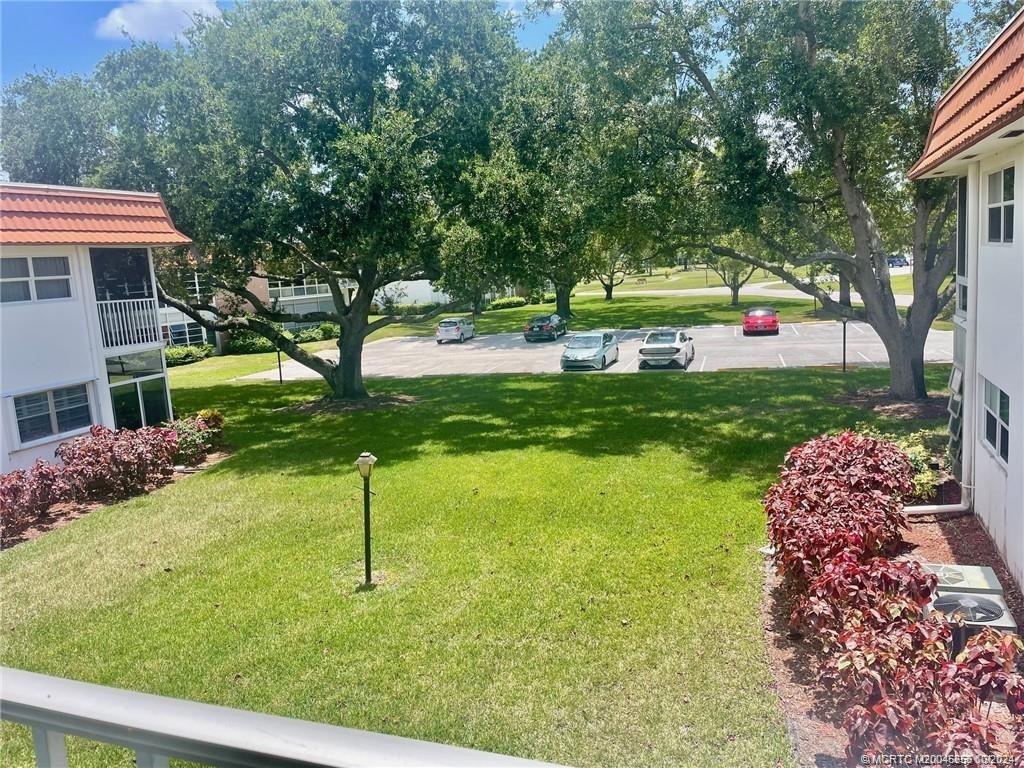 1225 Northwest 21st Street, Unit 3014 Stuart, FL 34994 - Photo 34 of 37 a house with garden in front of it