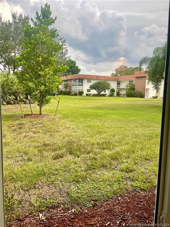 1225 Northwest 21st Street, Unit 3014 Stuart, FL 34994 - Photo 36 of 37 a view of an outdoor space and a yard