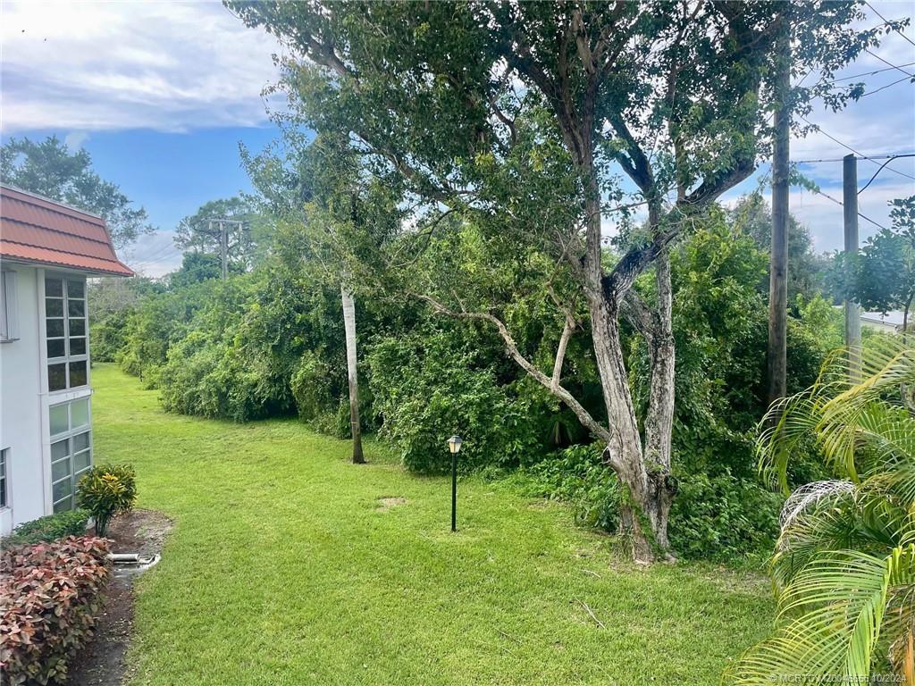 1225 Northwest 21st Street, Unit 3014 Stuart, FL 34994 - Photo 4 of 37 a green field with lots of trees