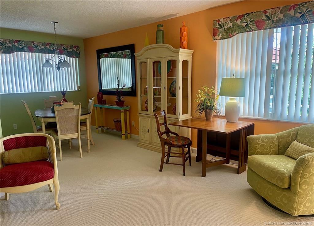 1225 Northwest 21st Street, Unit 3014 Stuart, FL 34994 - Photo 6 of 37 a living room with furniture and a large window