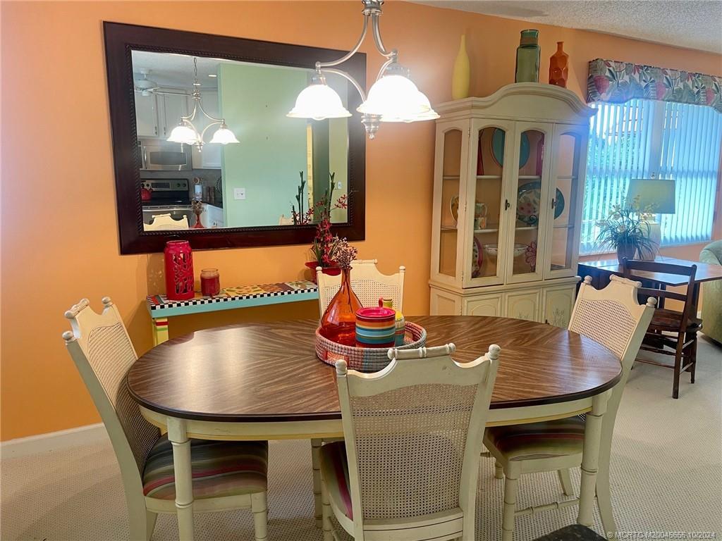 1225 Northwest 21st Street, Unit 3014 Stuart, FL 34994 - Photo 8 of 37 a dining room with furniture and window