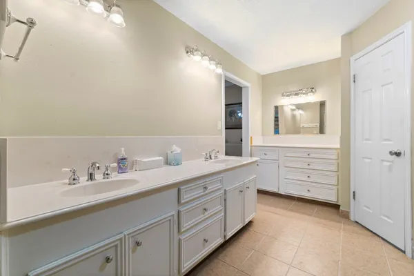 a spacious bathroom with a double vanity sink mirror and