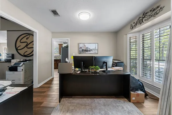 a work room with furniture a chandelier and a window