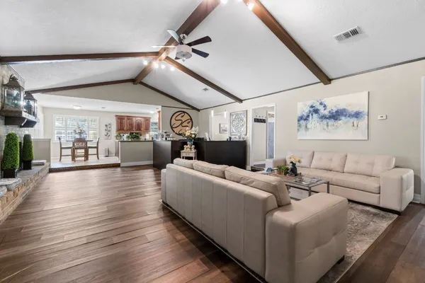 a living room with furniture and wooden floor