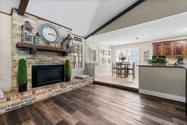 a living room with furniture a clock and a fireplace