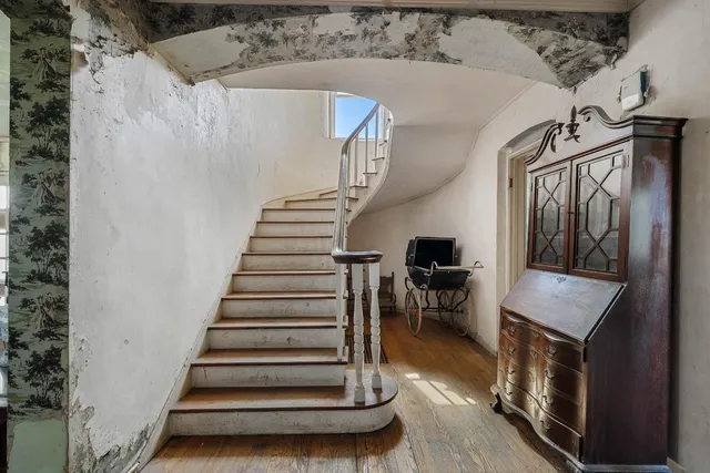 a view of a hallway to a bedroom and a window