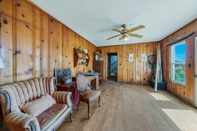 a view of a livingroom with furniture hardwood floor and workspace