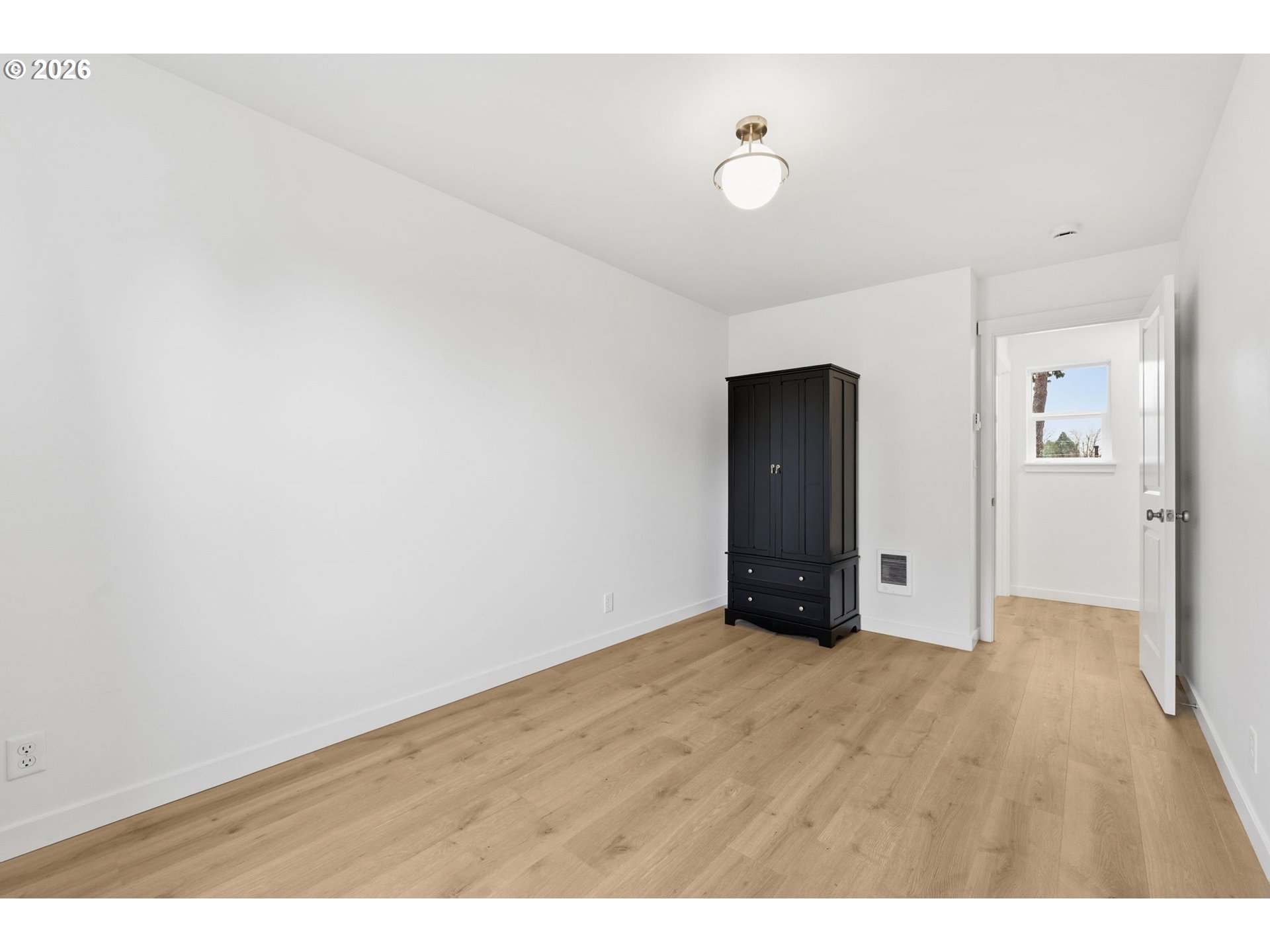 5592 Burnett Avenue, Unit B Eugene, OR 97402 - Photo 25 of 36 a view of an empty room with wooden floor