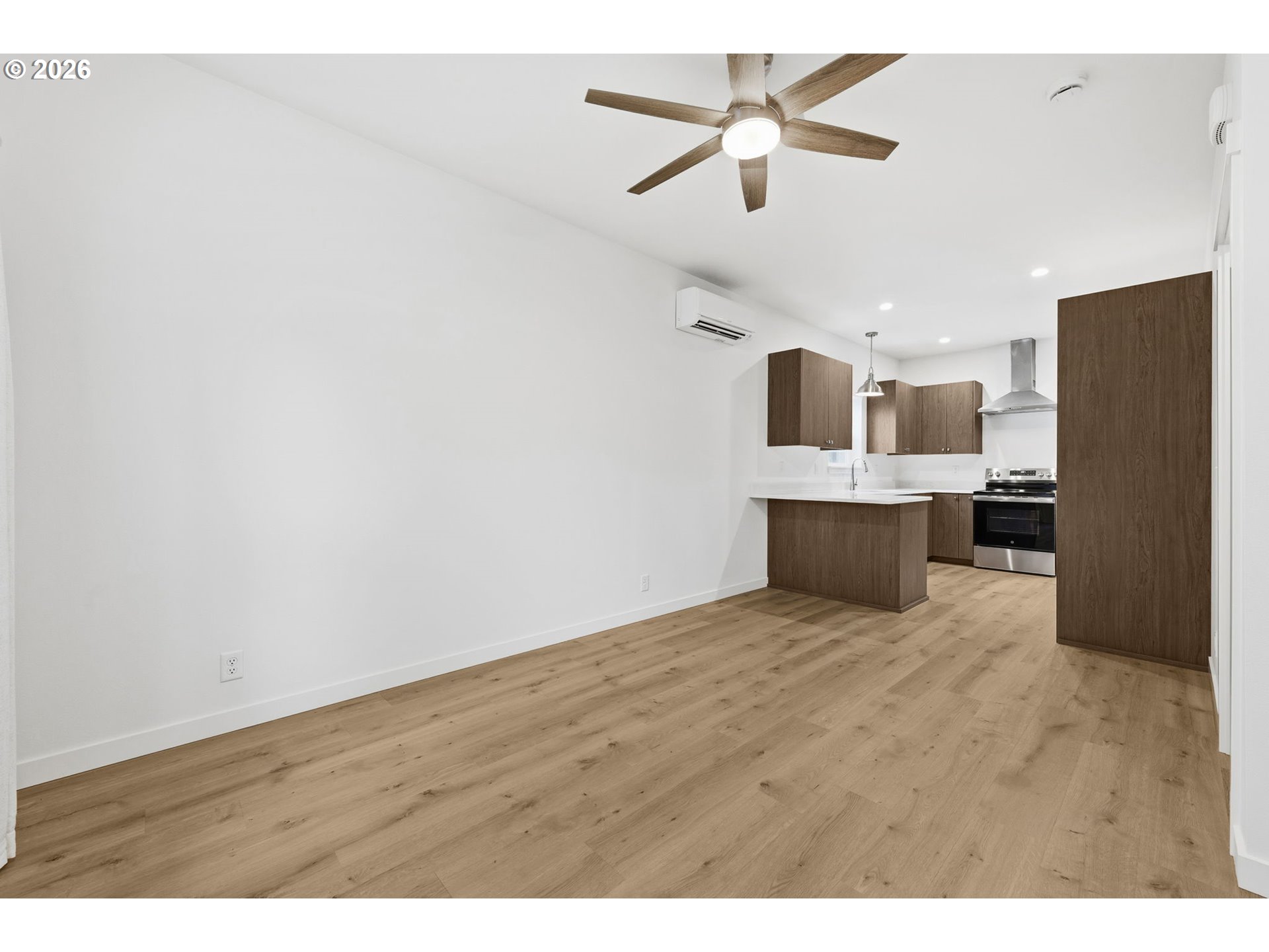 5592 Burnett Avenue, Unit B Eugene, OR 97402 - Photo 9 of 36 a view of kitchen and empty room with wooden floor