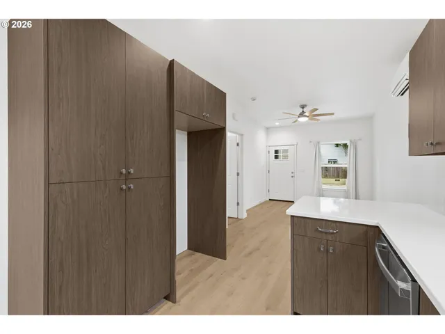 a kitchen with a sink cabinets and a window