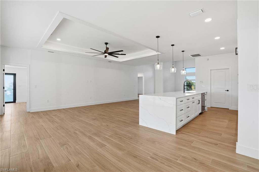 3903 15th Street Southwest Lehigh Acres, FL 33976 - Photo 12 of 44 a view of a kitchen with marble the kitchen counter top and wooden floor