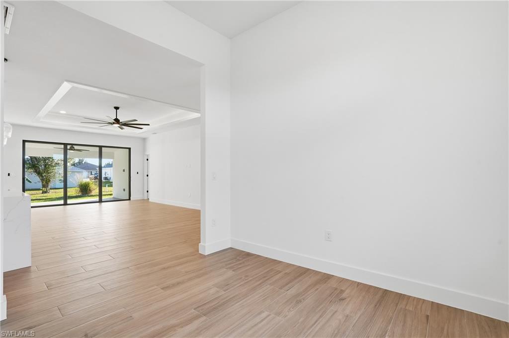 3903 15th Street Southwest Lehigh Acres, FL 33976 - Photo 15 of 44 a view of an empty room with wooden floor and a window