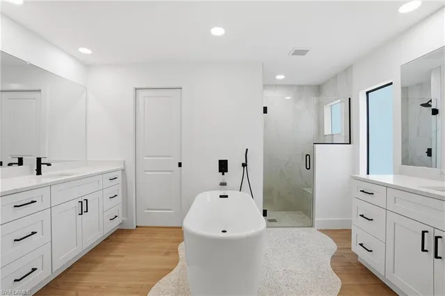 a bathroom with a double vanity sink and mirror