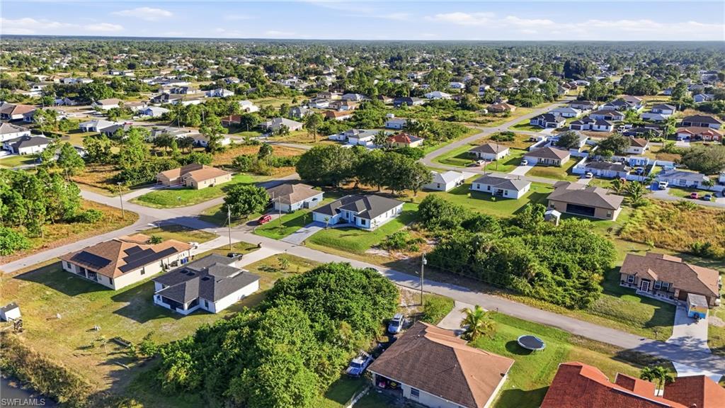 3903 15th Street Southwest Lehigh Acres, FL 33976 - Photo 2 of 44 an aerial view of residential houses with outdoor space