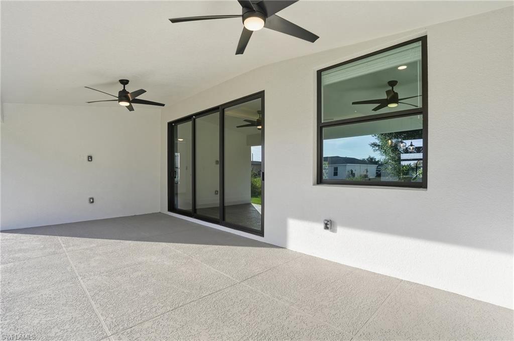 3903 15th Street Southwest Lehigh Acres, FL 33976 - Photo 35 of 44 a view of a hallway with wooden floor and a chandelier fan