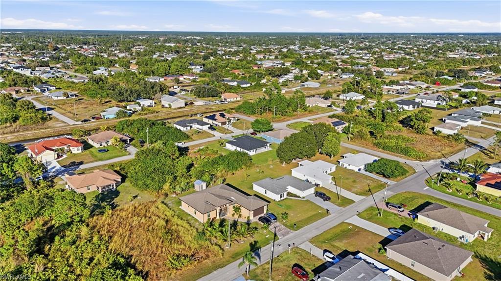 3903 15th Street Southwest Lehigh Acres, FL 33976 - Photo 41 of 44 an aerial view of residential houses with outdoor space
