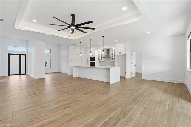 a view of a kitchen with a sink and refrigerator
