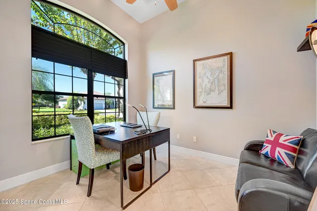 a view of a patio with chairs and an umbrella