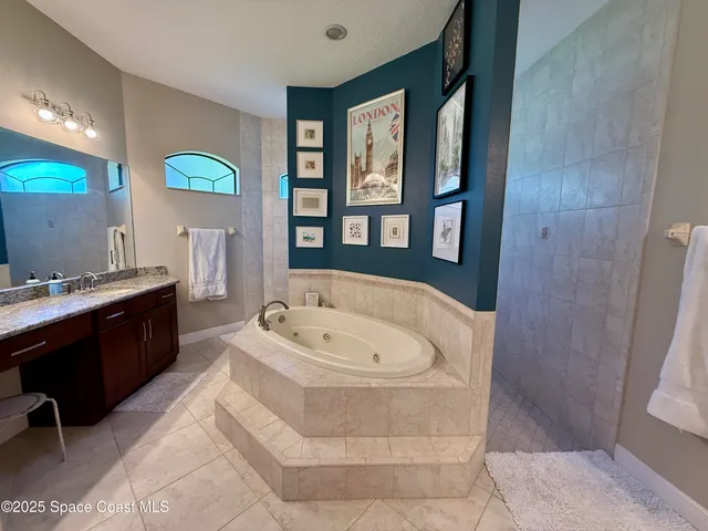 a bedroom with bed and a painting on the wall