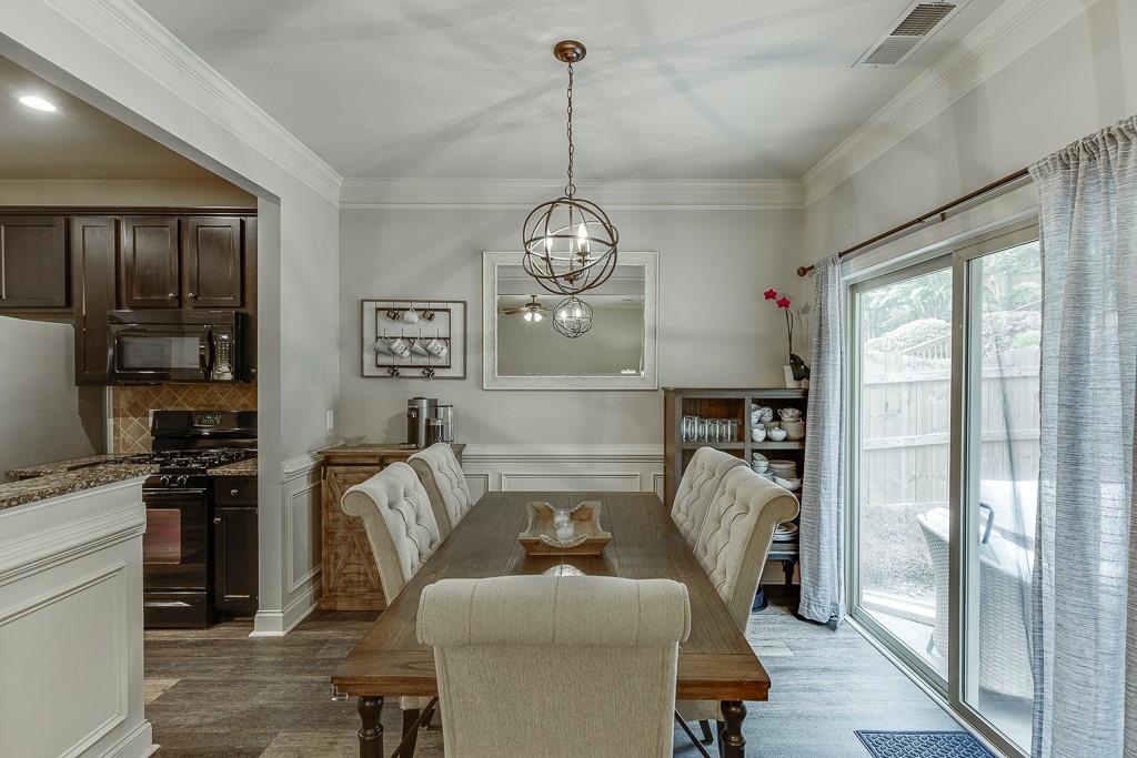 2140 Harvest Ridge Circle Northeast Buford, GA 30519 - Photo 13 of 38 a living room with furniture a chandelier and a chandelier
